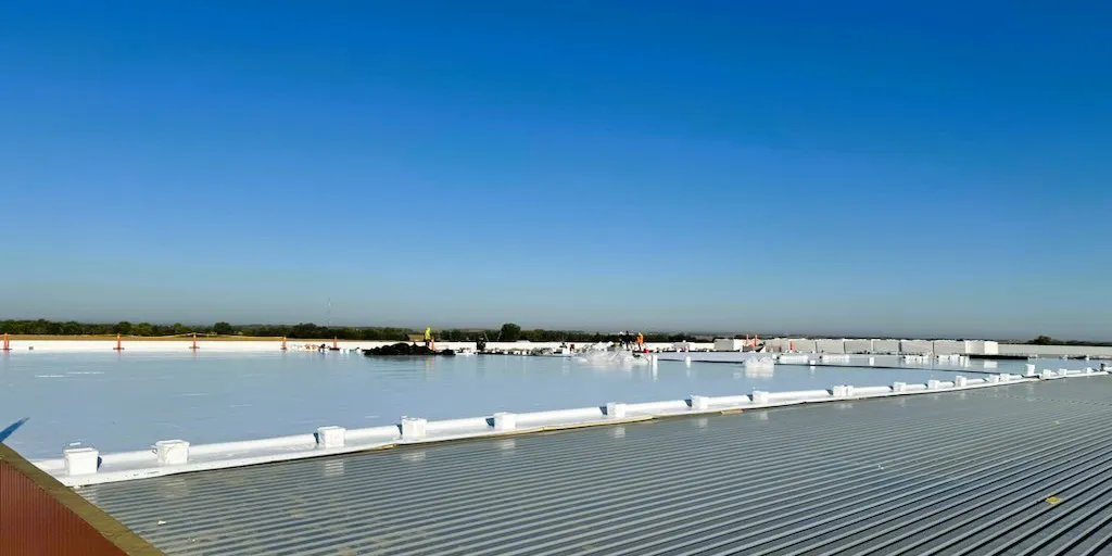 A rooftop with people working.