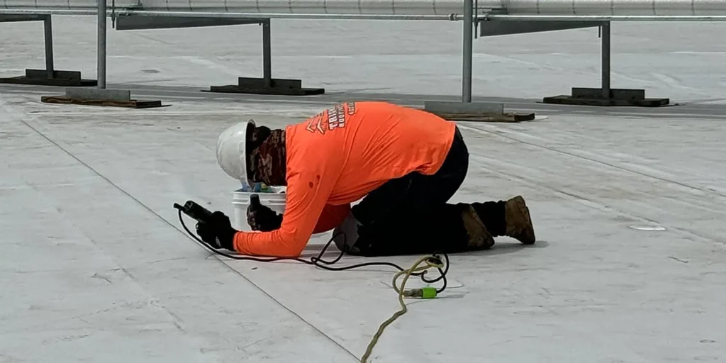 Worker from Triumph working on a roof.