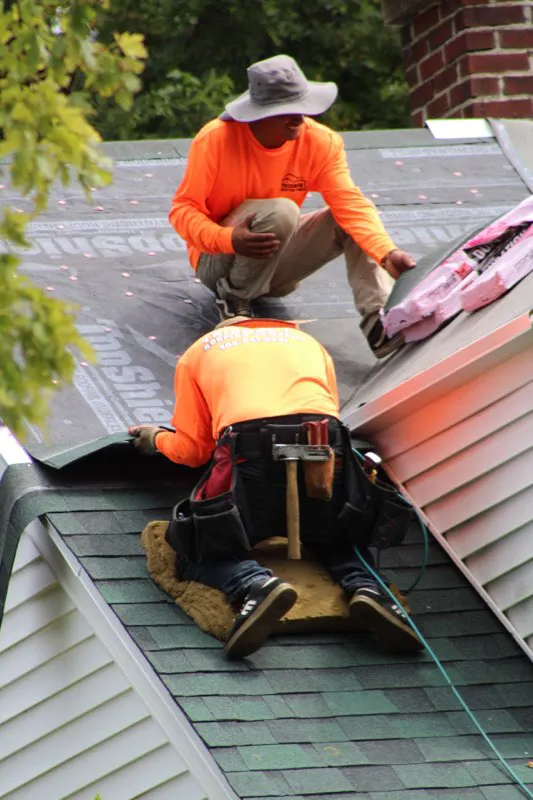 Residential home being shingles by Triumph Roofing Company