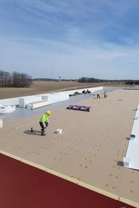 Employee on roof. Triumph Roofing Company.