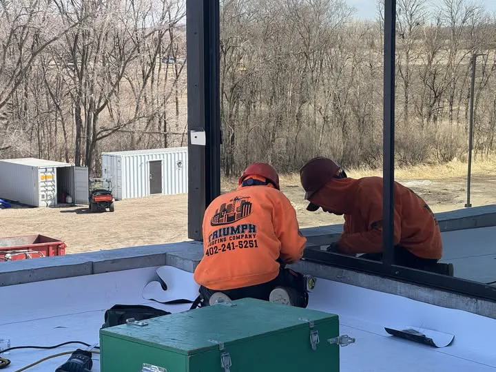 Triumph Roofing employeed working on commercial roof.